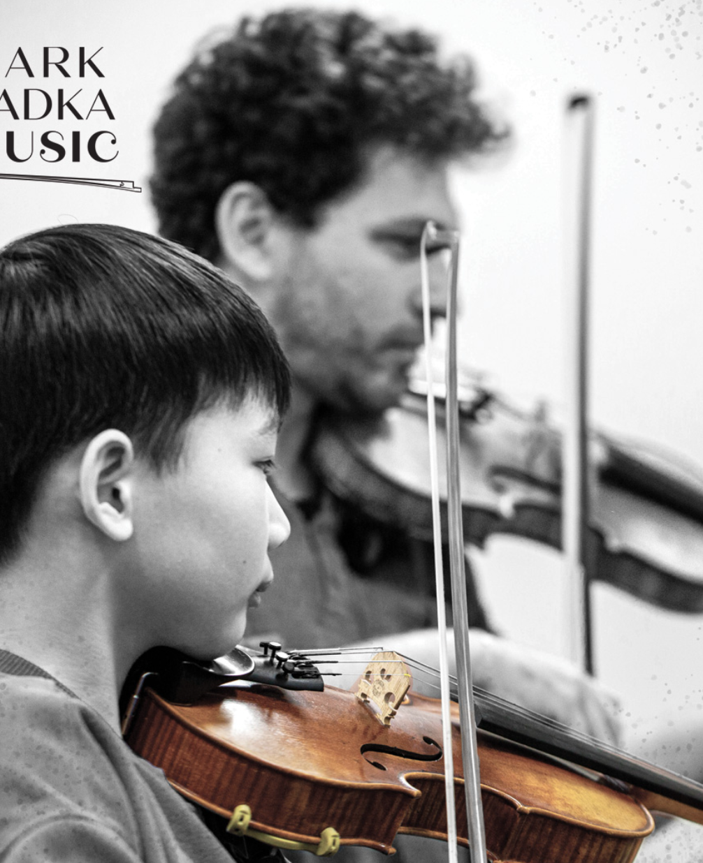A student and Mark Sadka playing violin side by side, with the Mark Sadka Music logo in the corner