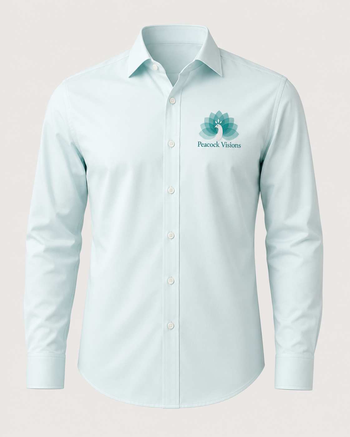 Pale mint shirt embroidered with the Peacock Visions lotus peacock logo and wordmark